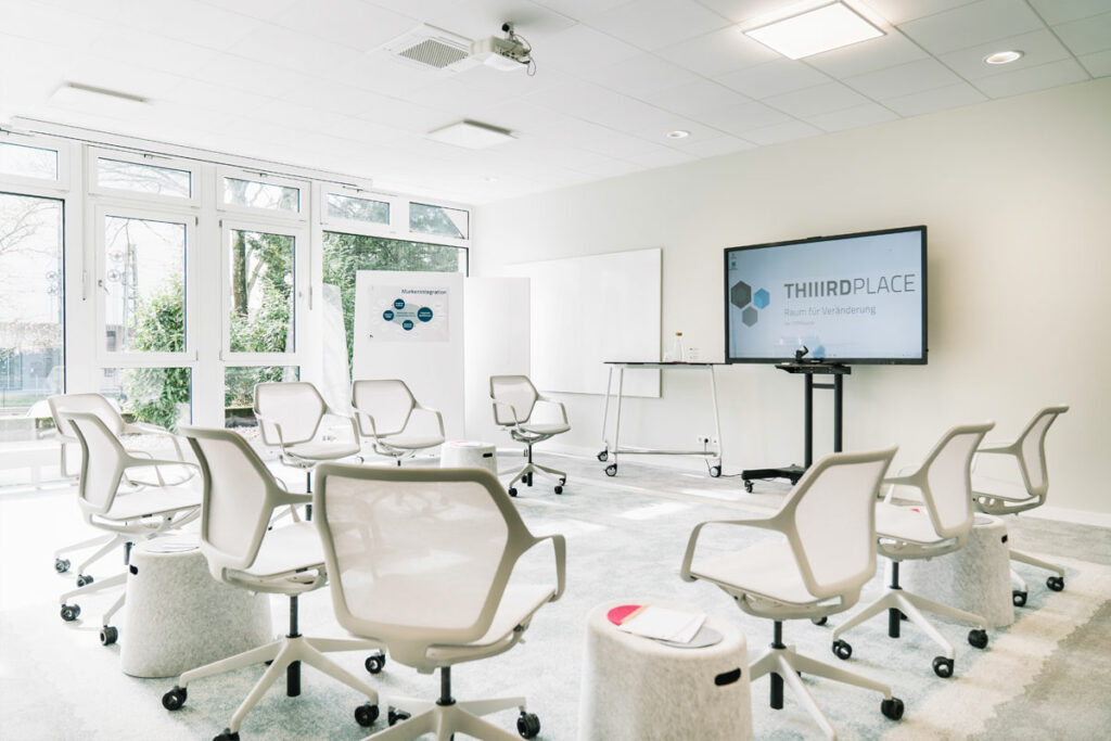 Tagungsraum mit Beamer und Stuhlreihen - perfekter Eventraum für Seminarräume und Meetingräume